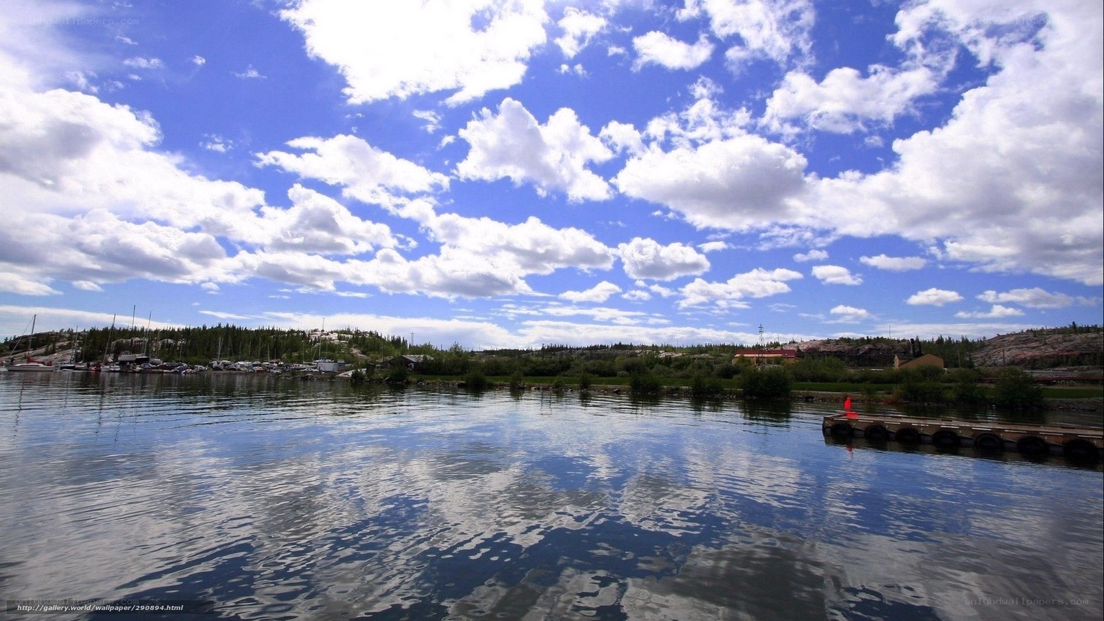 Lake with boats and clouds