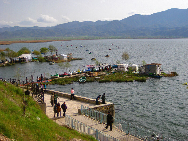Lake with boats and mountains