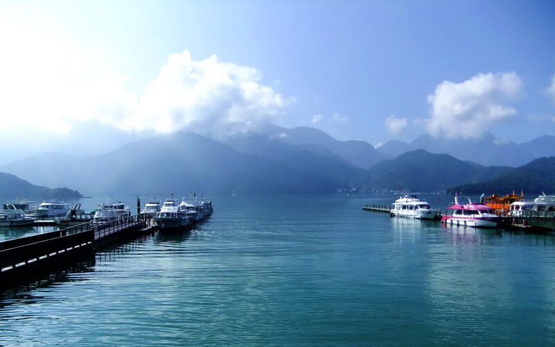 Lake with boats and mountains