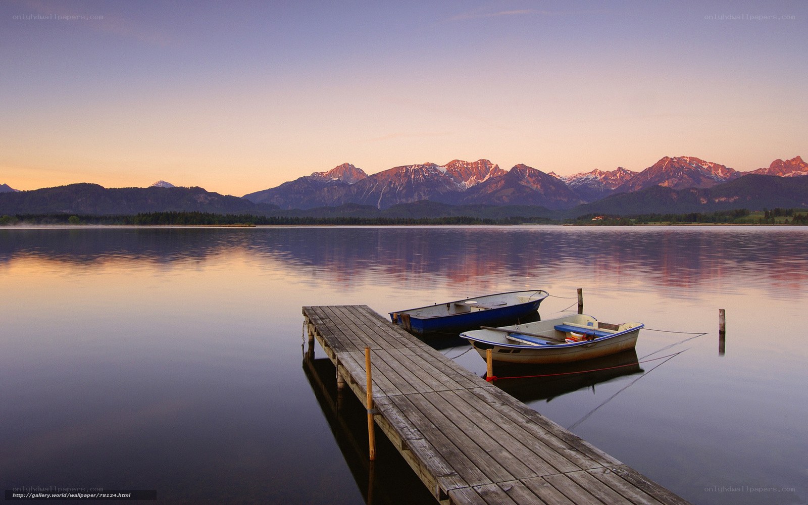 Lake with boats and mountains