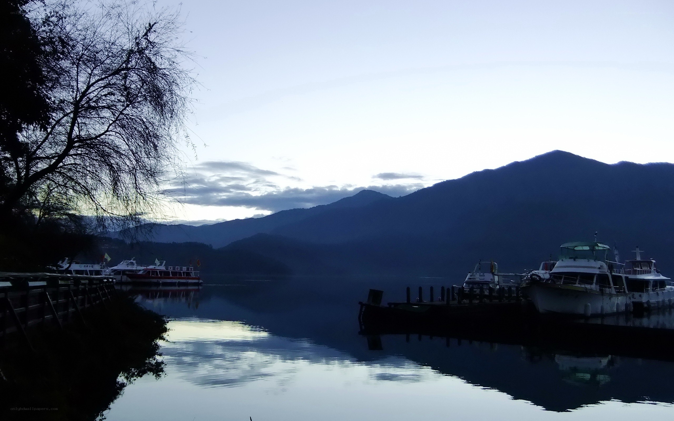 Lake with boats at dusk