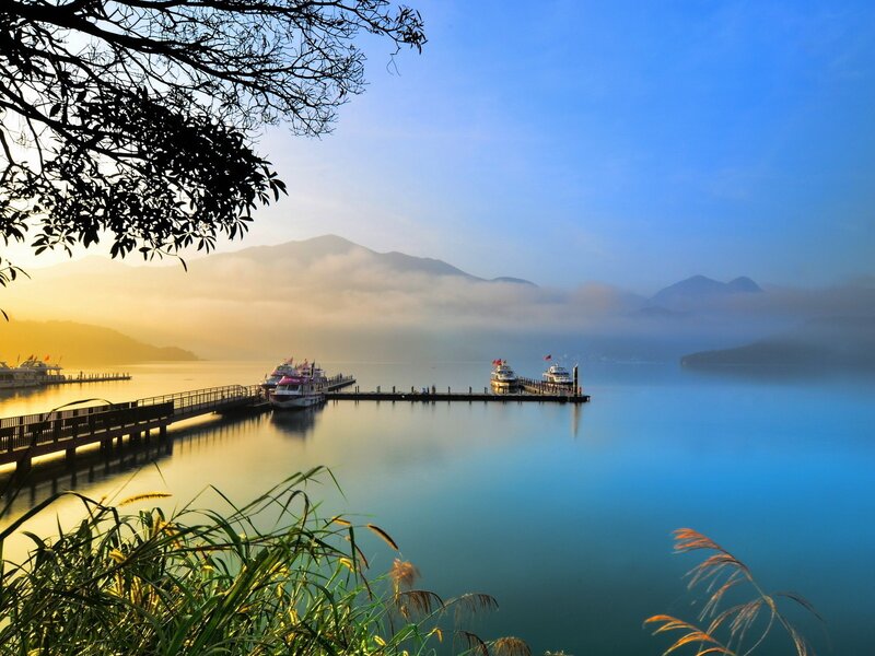 Lake with boats at sunrise