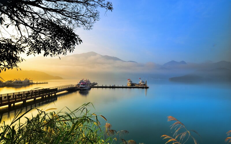 Lake with boats at sunrise