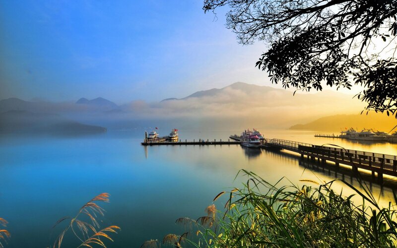 Lake with boats at sunrise