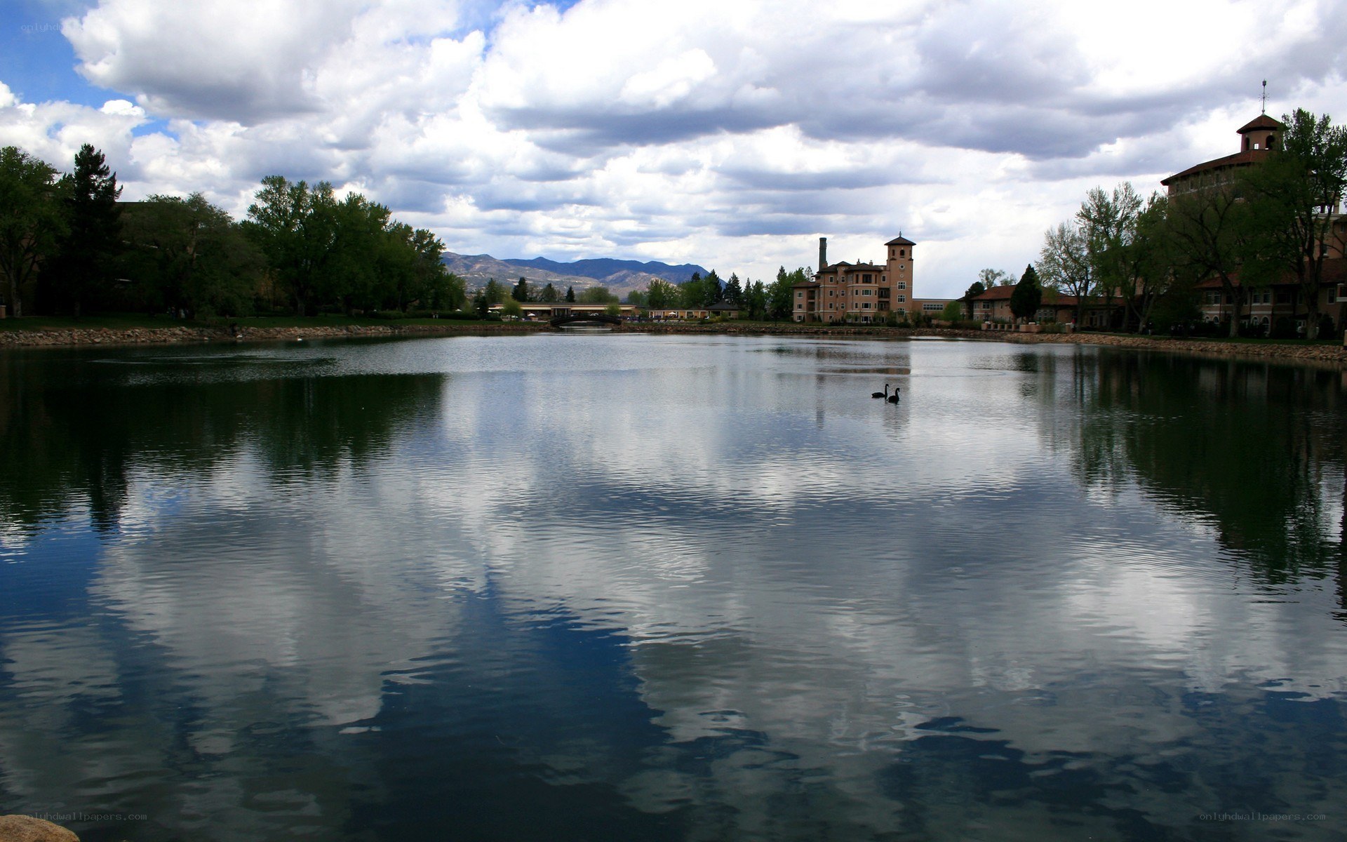 Lake with buildings and mountains