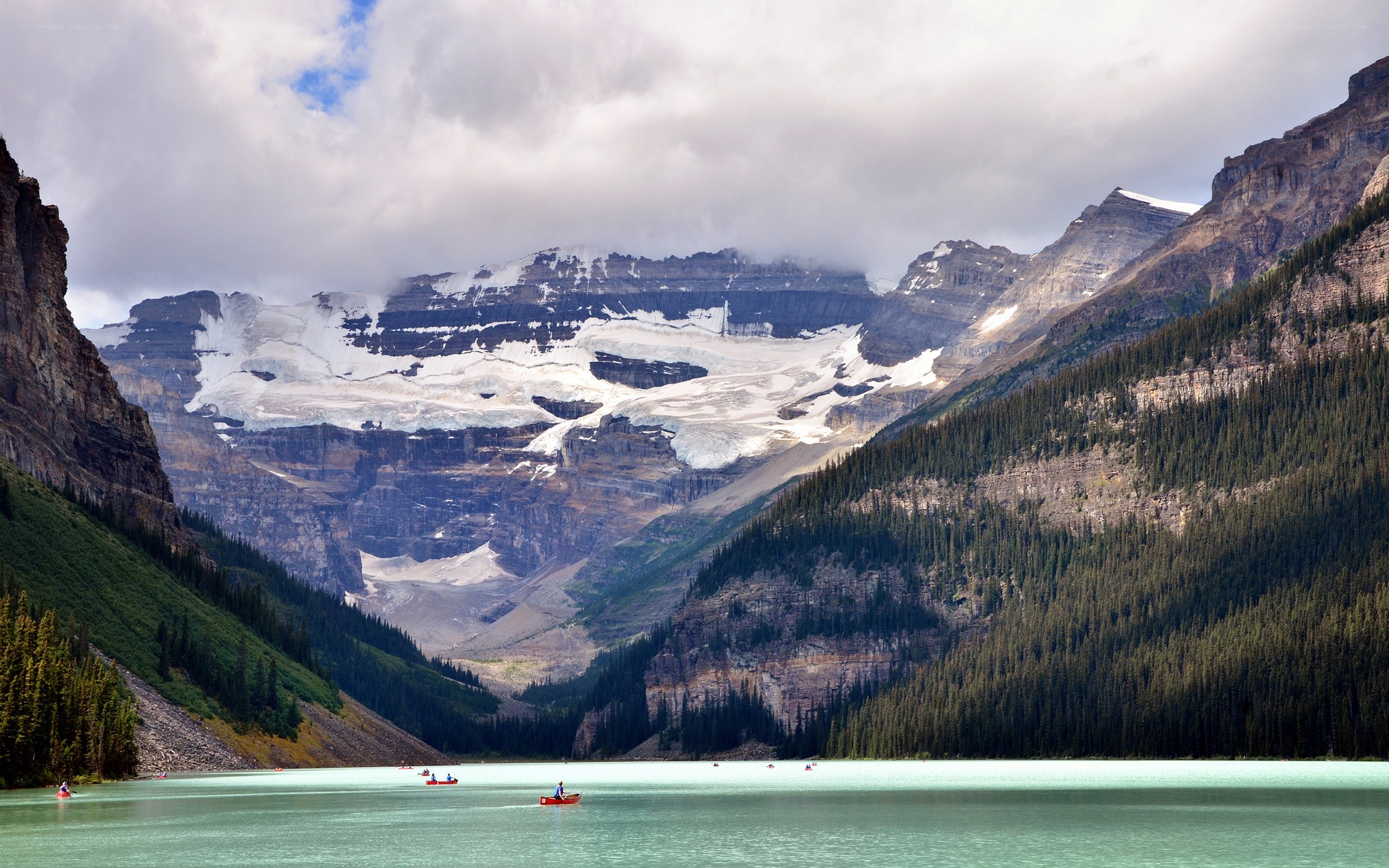 Lake with canoes and mountains