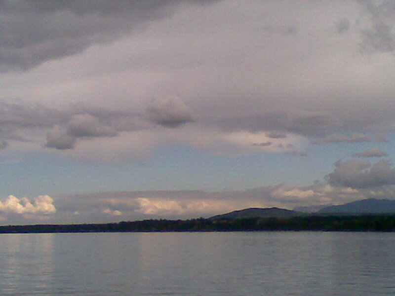 Lake with cloudy sky and hills