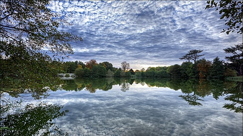 Lake with cloudy sky reflection