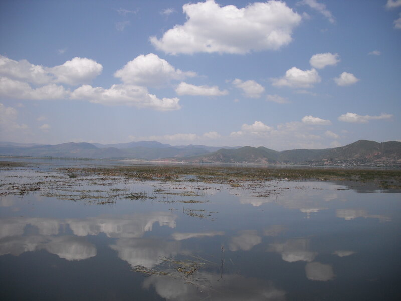 Lake with cloudy sky reflection