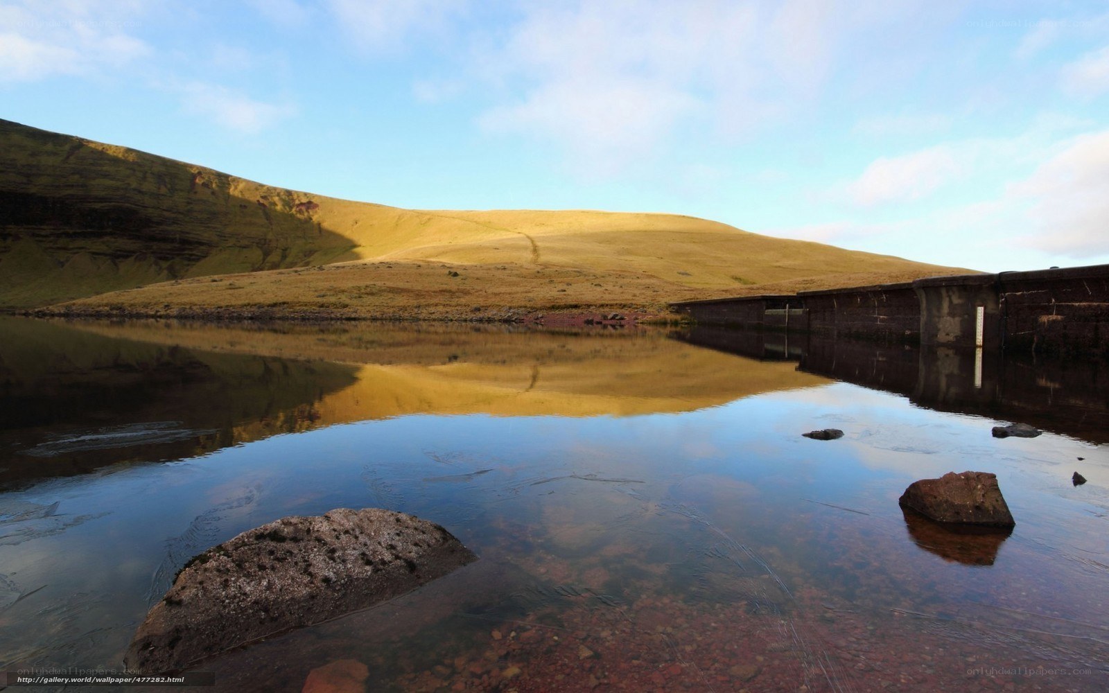 Lake with dam and hills