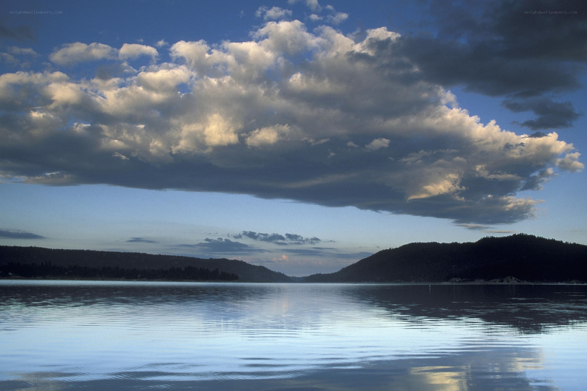 Lake with dramatic clouds at dusk