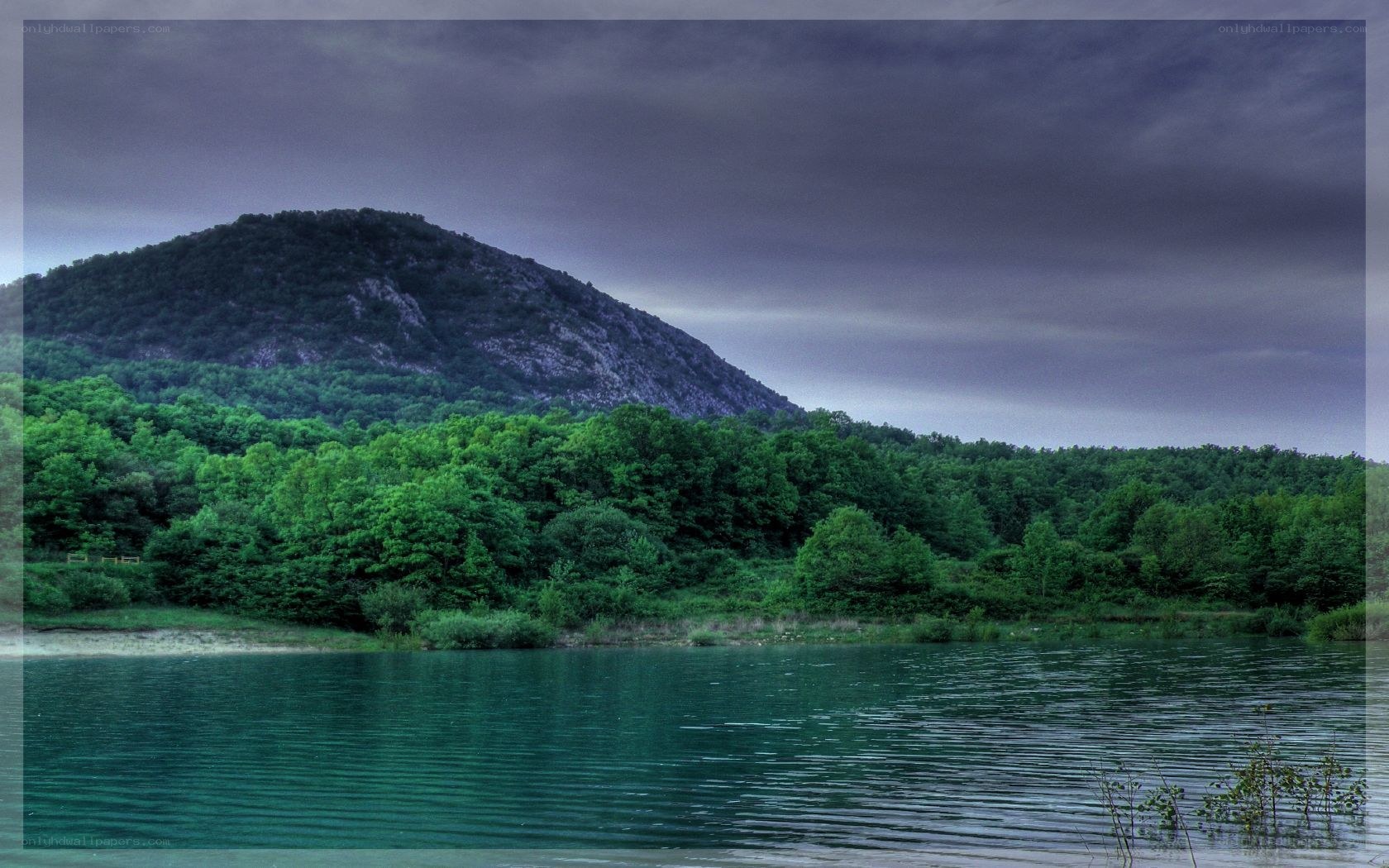 Lake with forested mountain