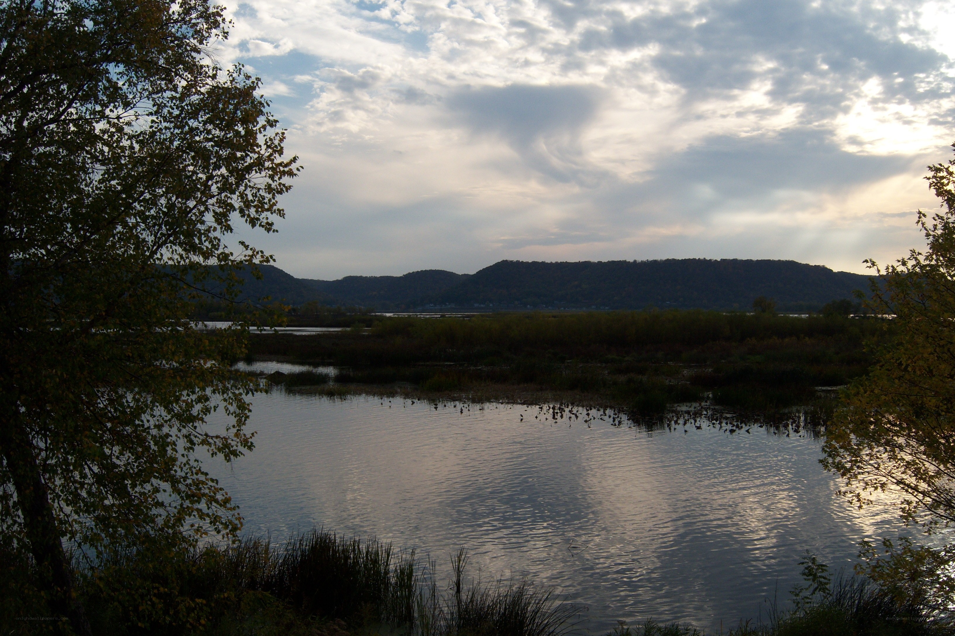 Lake with hills at sunset