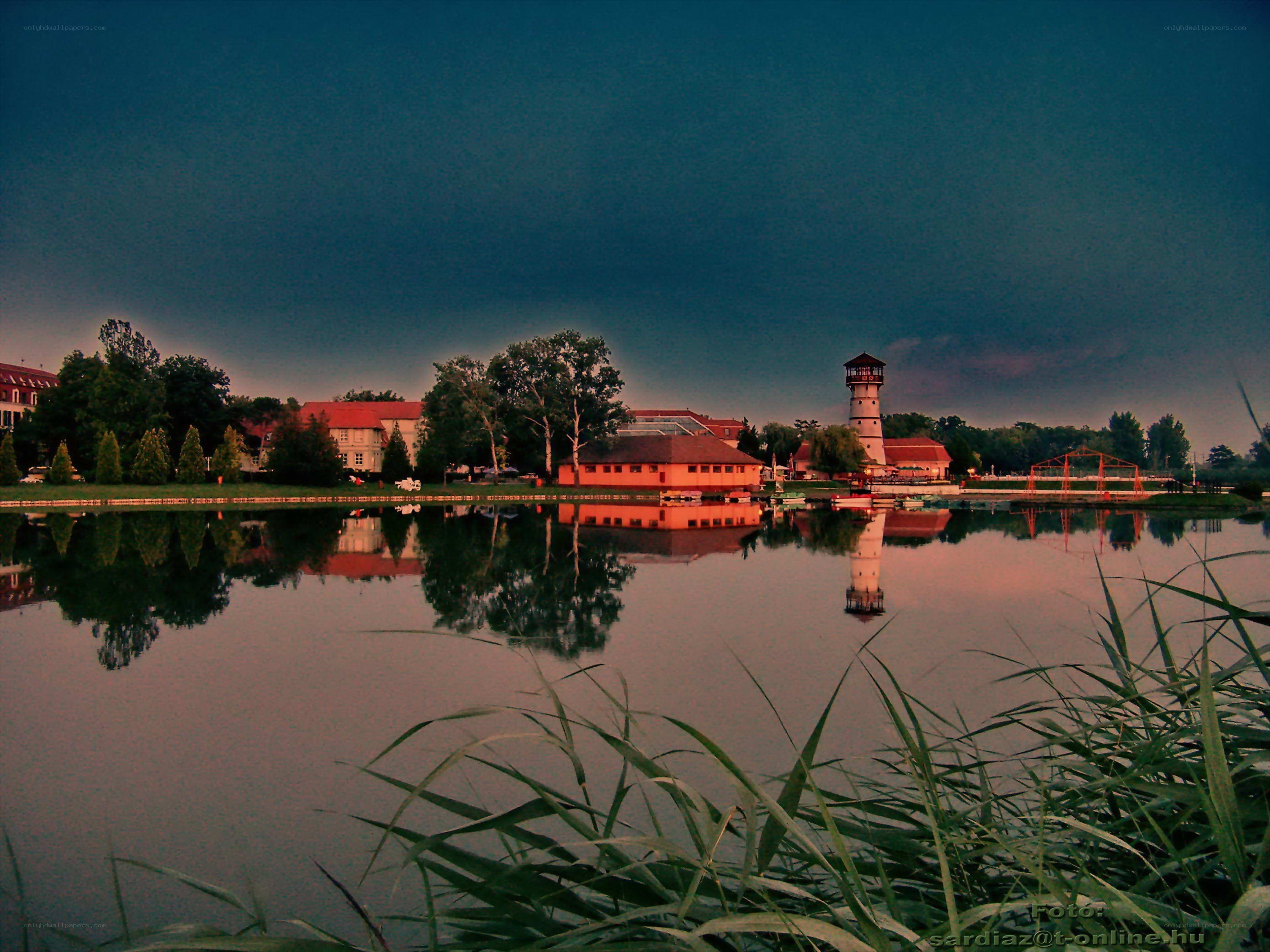 Lake with lighthouse at dusk