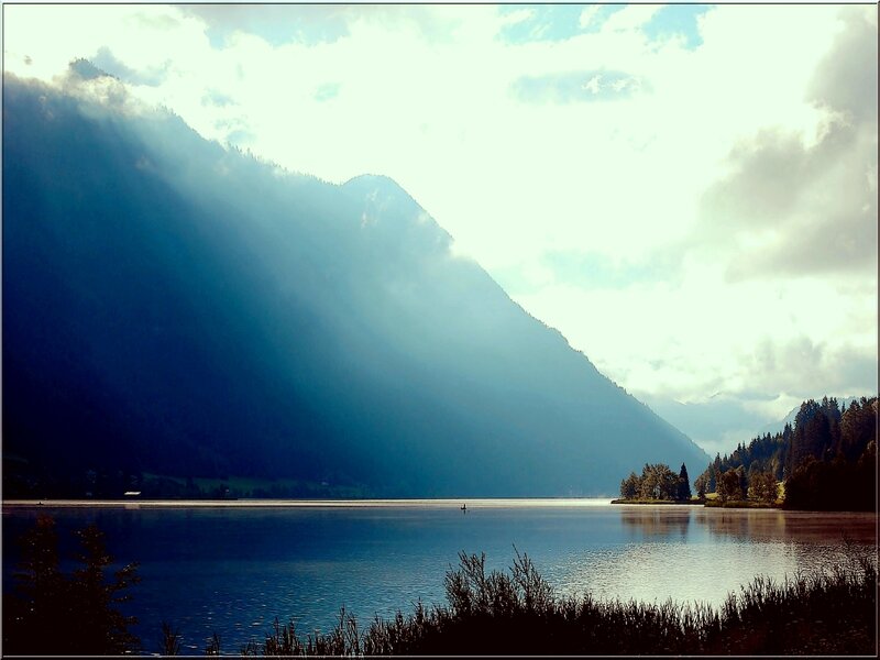 Lake with mountain and sunbeams