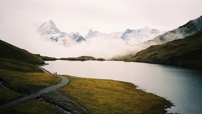 Lake with mountain peaks in fog