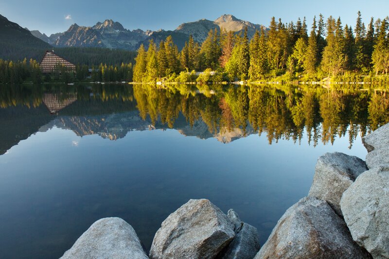 Lake with Mountain Reflection — Blue, Serene, Morning, Photograph, Mountains, Forest, Building