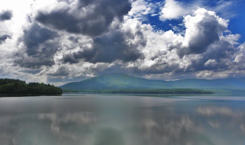 Lake with mountains and cloudy sky