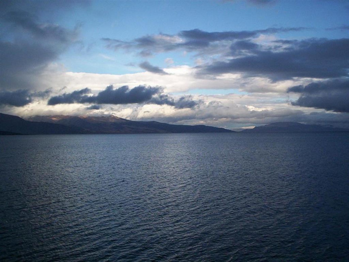 Lake with mountains and cloudy sky