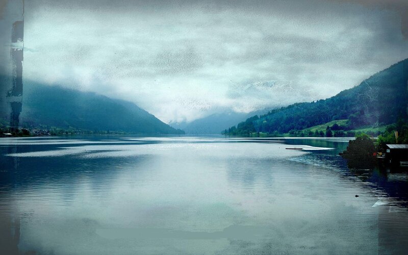 Lake with mountains and fog