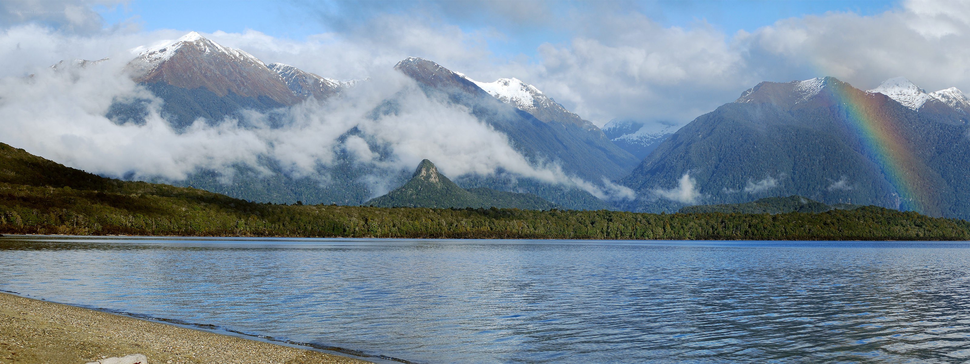 Lake with mountains and rainbow