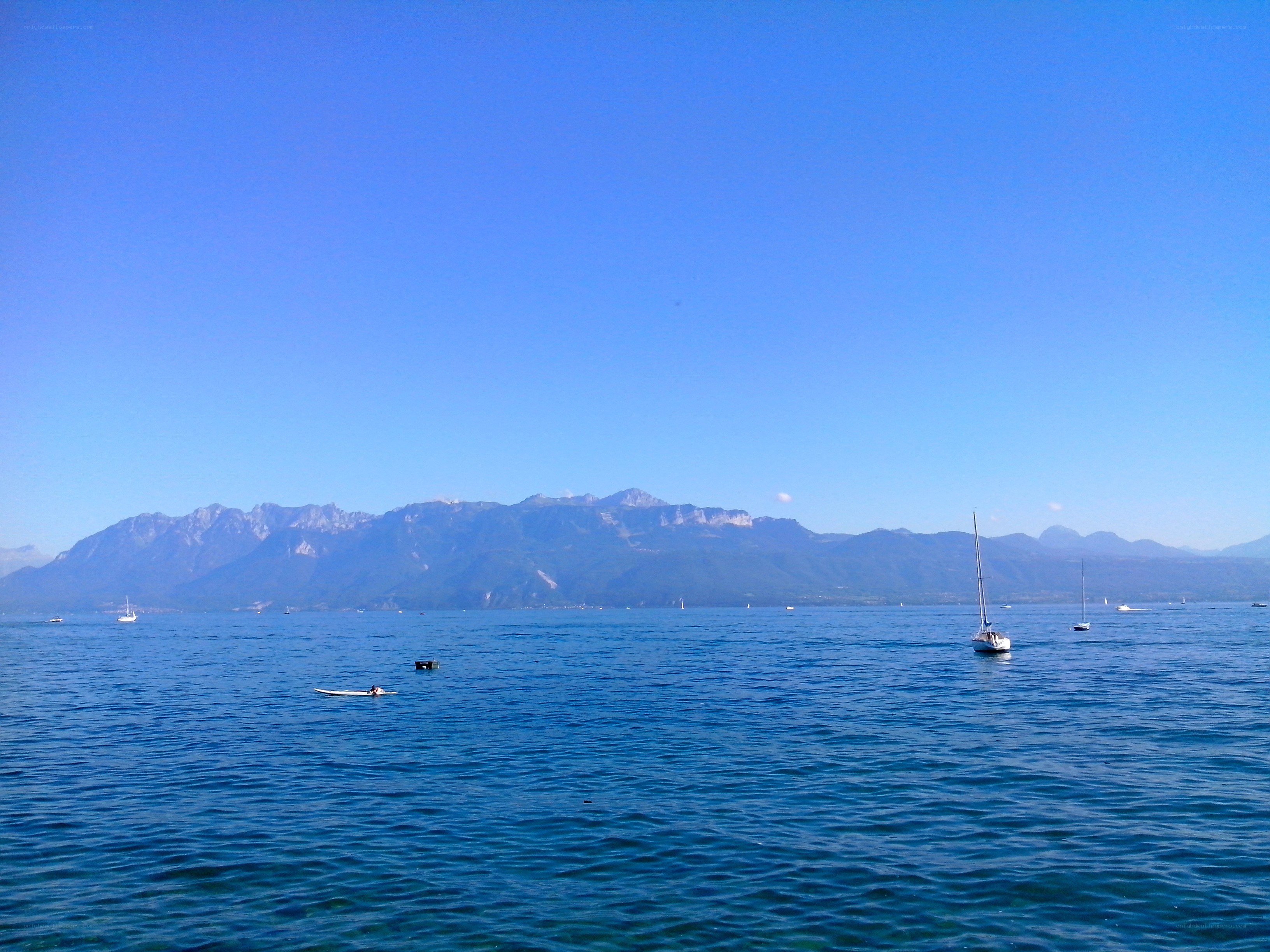 Lake with mountains and sailboats