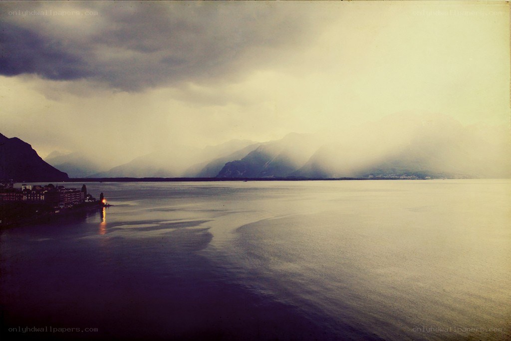 Lake with mountains and storm