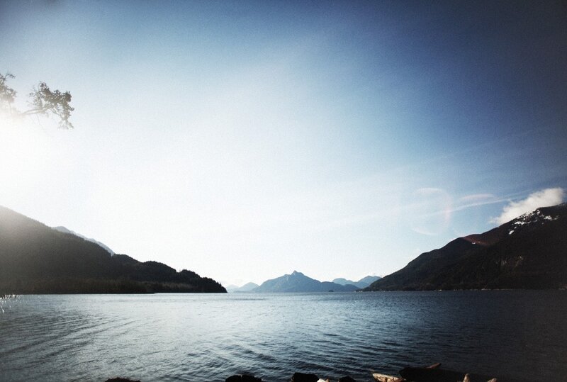 Lake with mountains and sun glare