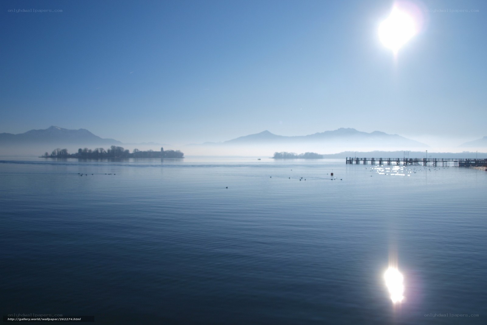Lake with mountains and sun
