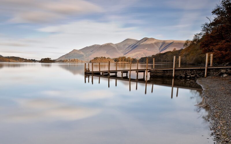 Lake with mountains and wooden pier