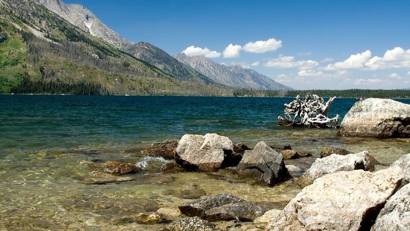 Lake with Mountains — Blue, Serene, Afternoon, Photograph, Driftwood, Rocks, Green