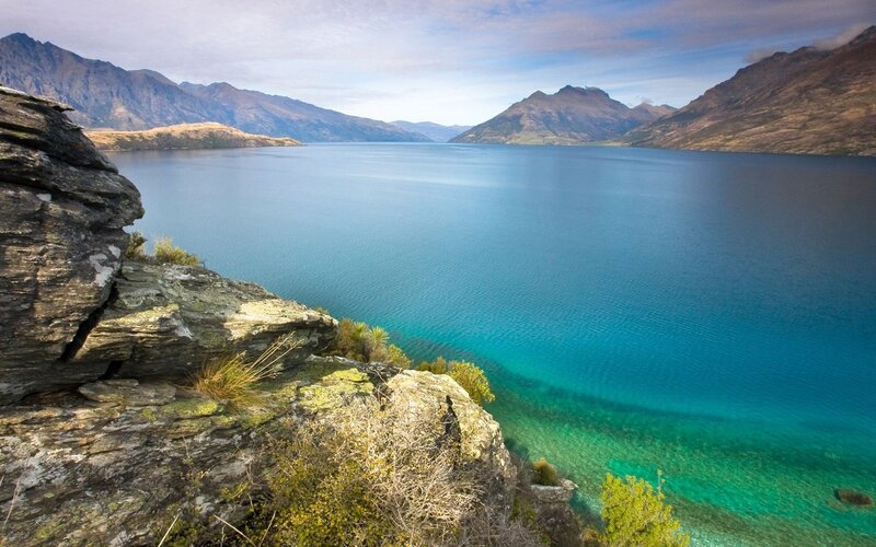 Lake with Mountains — Blue, Serene, Afternoon, Photograph, Rocks, Vegetation