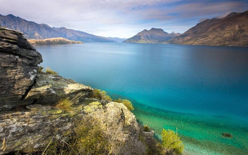 Lake with Mountains — Blue, Serene, Afternoon, Photograph, Rocky Shore
