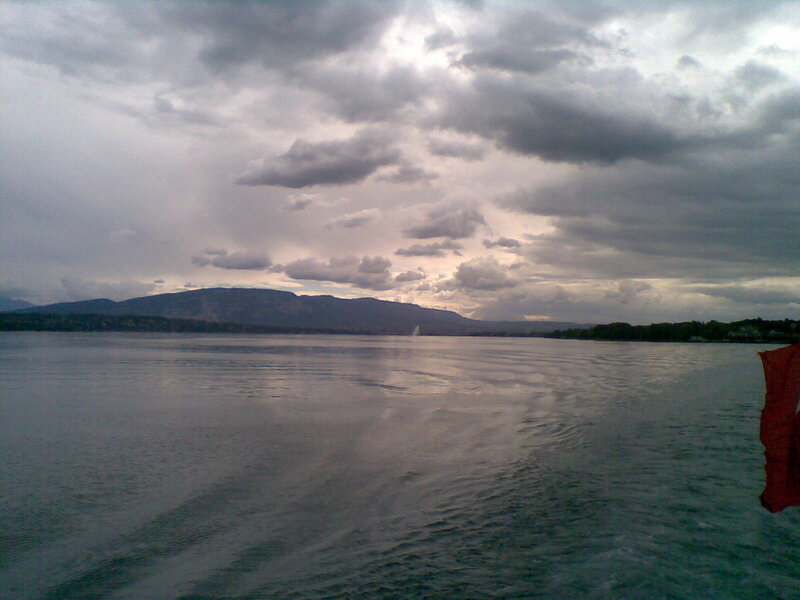 Lake with mountains under cloudy sky