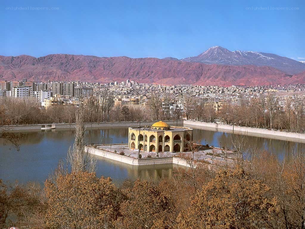 lake with pavilion and mountains