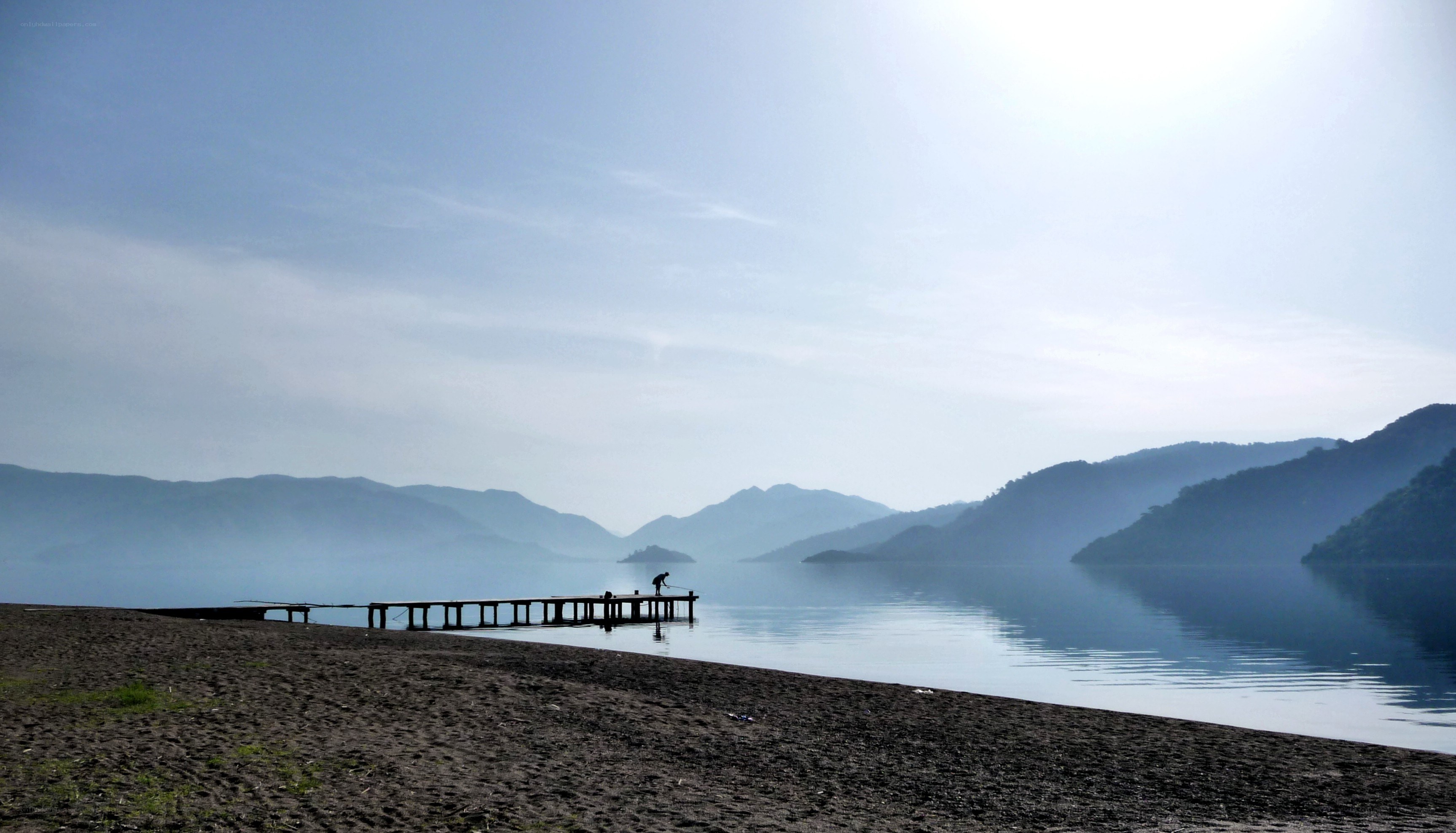 Lake with pier and mountains