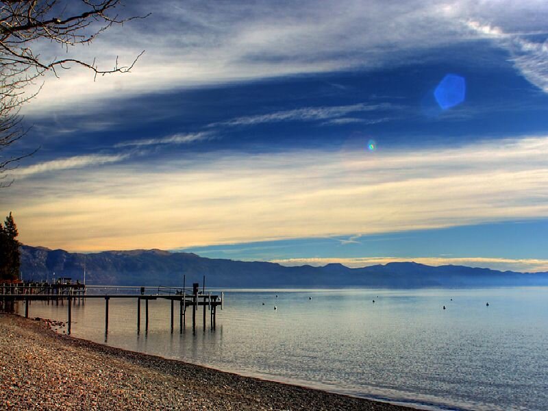 Lake with pier at sunset