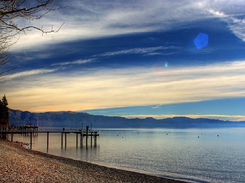 Lake with pier at sunset