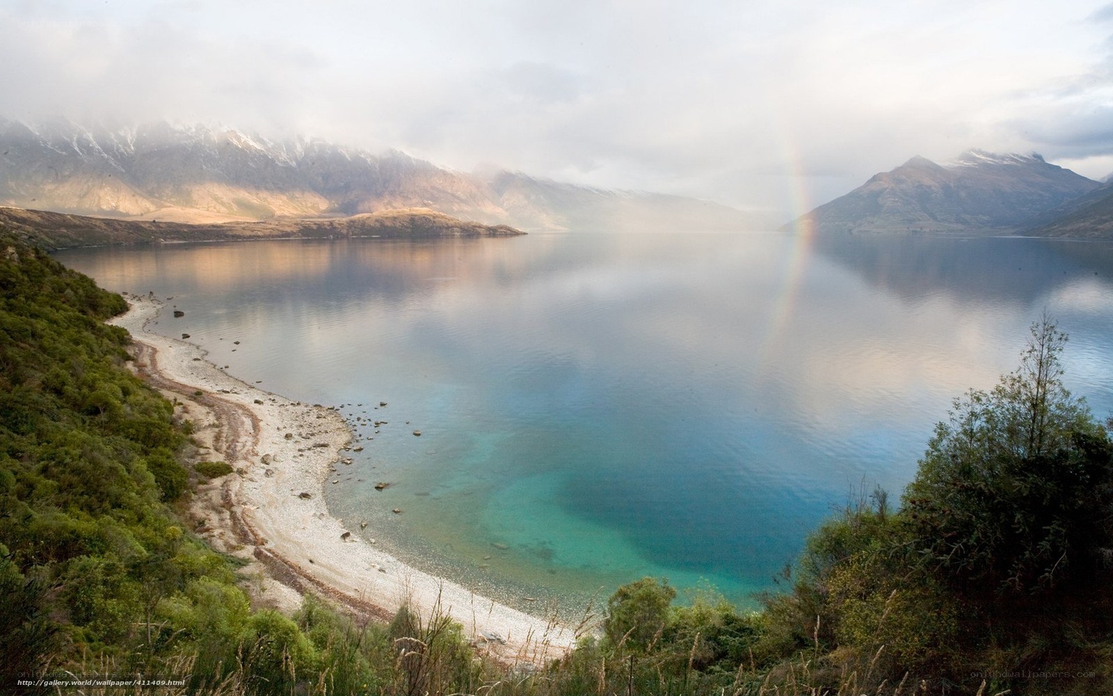 Lake with rainbow and mountains