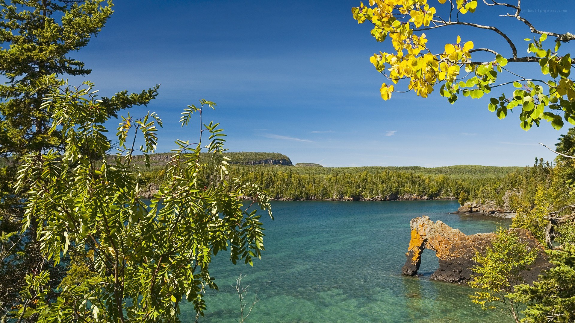 Lake with rock arch and forest