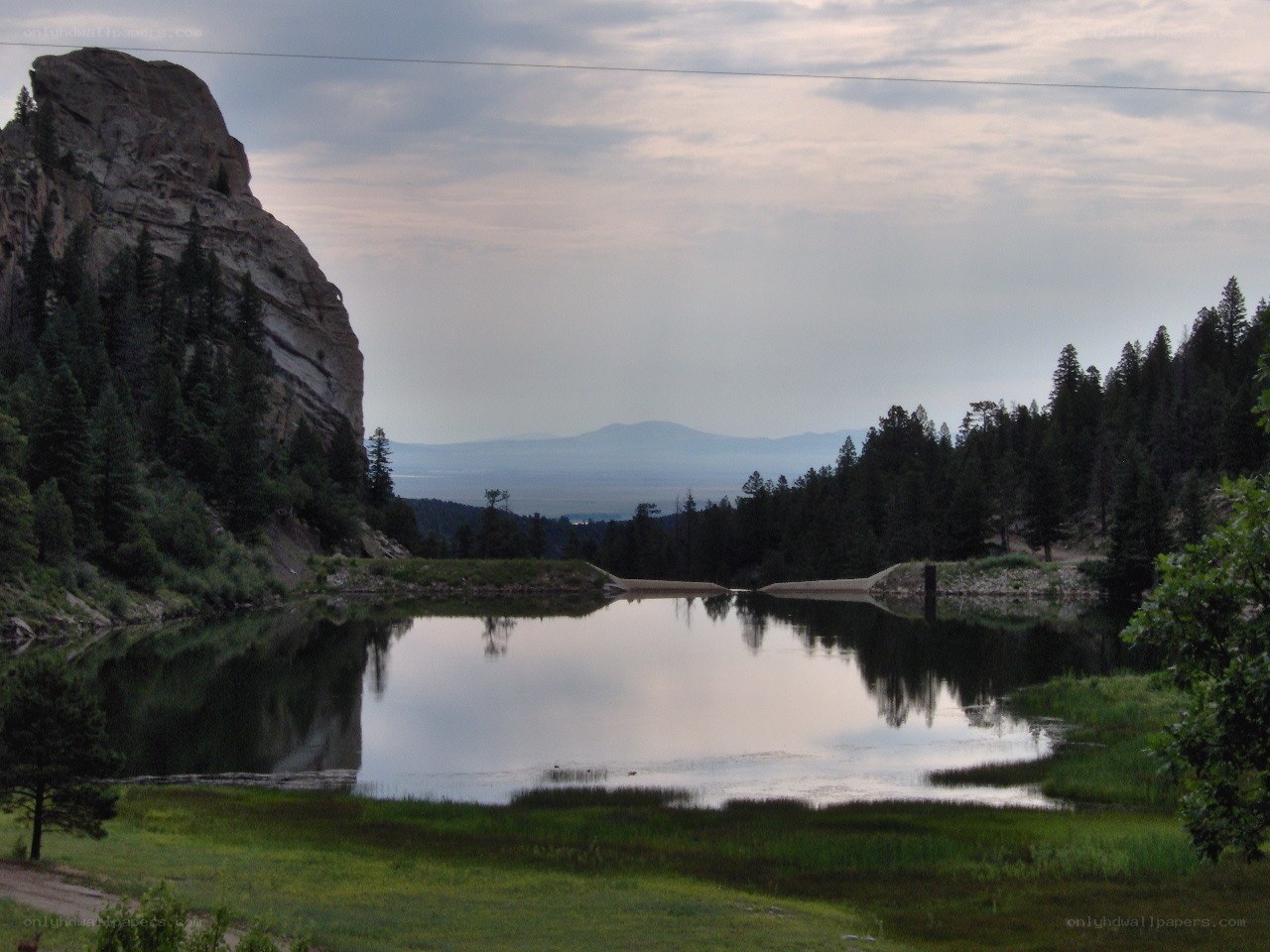 Lake with rock formation and forest