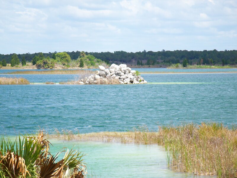 Lake with rock pile and reeds