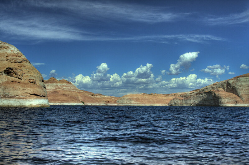 Lake with rocky cliffs and blue sky