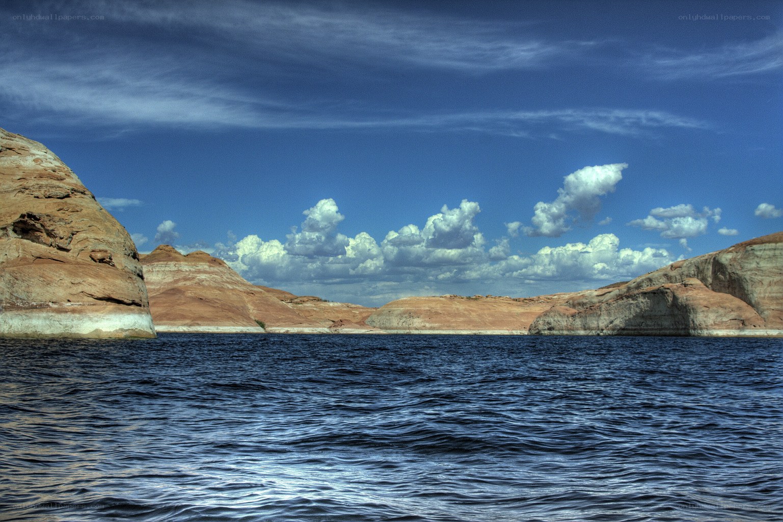 Lake with rocky cliffs and blue sky