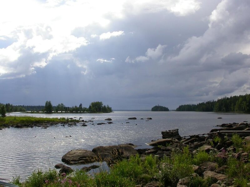 Lake with rocky shore and cloudy sky