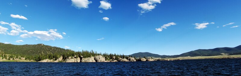 Lake with rocky shore and mountains