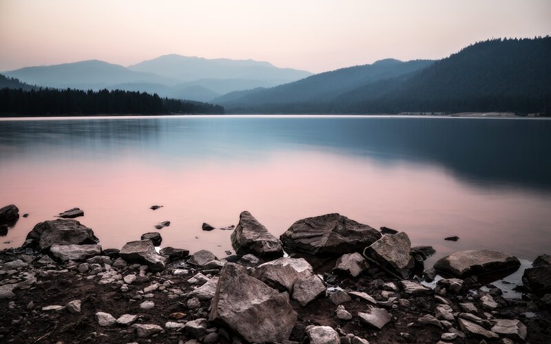 Lake with Rocky Shore — Blue, Serene, Sunset, Photograph, Mountains