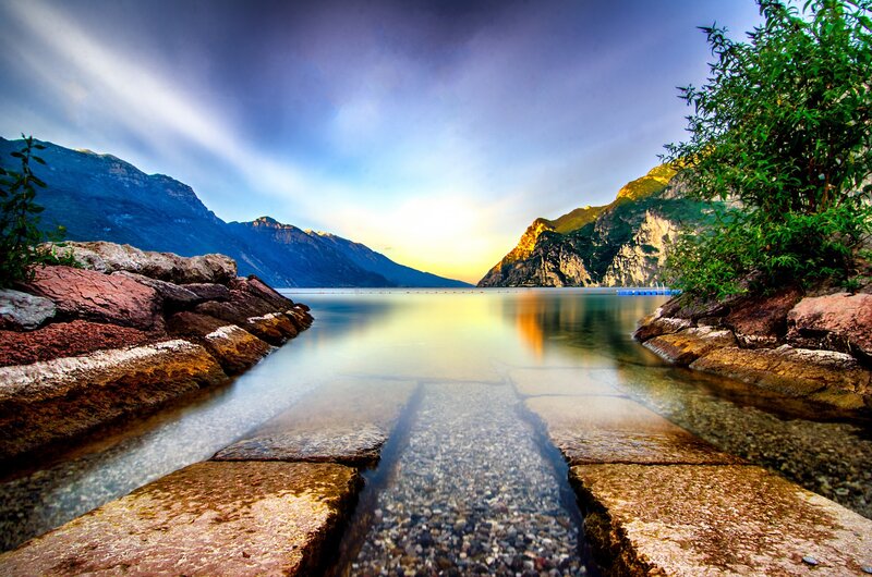 Lake with Rocky Shore — Blue, Serene, Sunset, Photograph, Mountains, Trees
