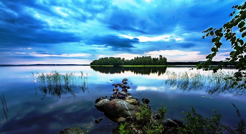 Lake with Rocky Shore — Blue, Serene, Sunset, Photograph, Trees
