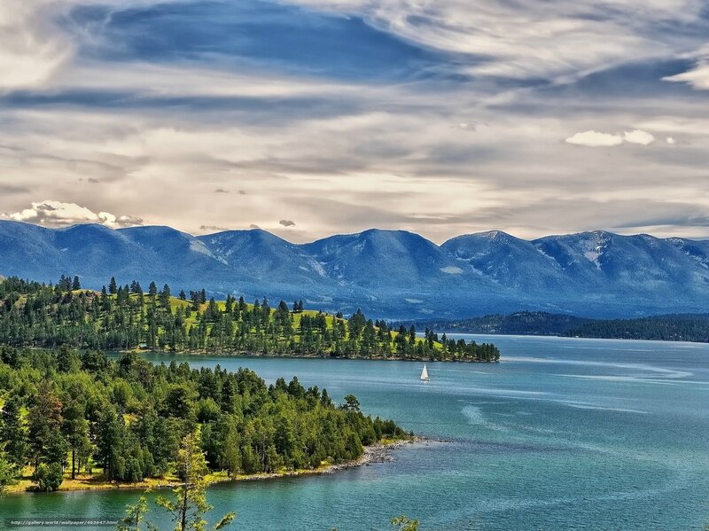 Lake with sailboat and mountains
